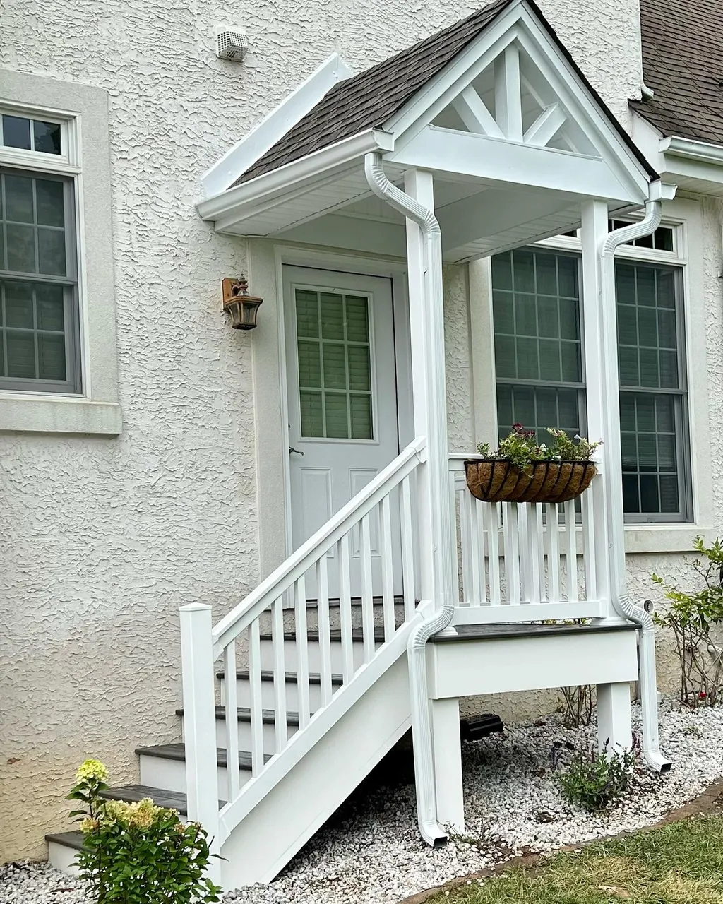 White exterior portico and railing built by Delpa Builders